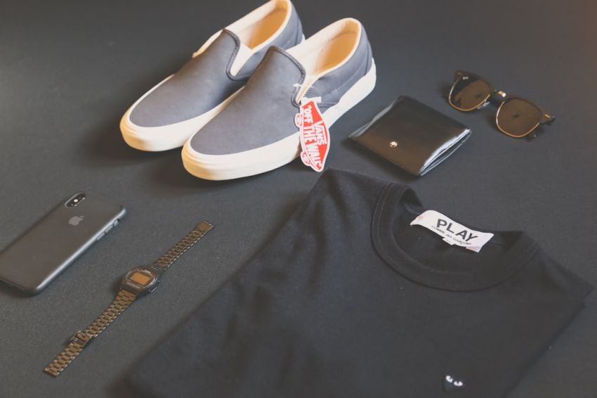 Men's Fashion - folded black Play shirt beside iPhone X, digital watch, and sneakers