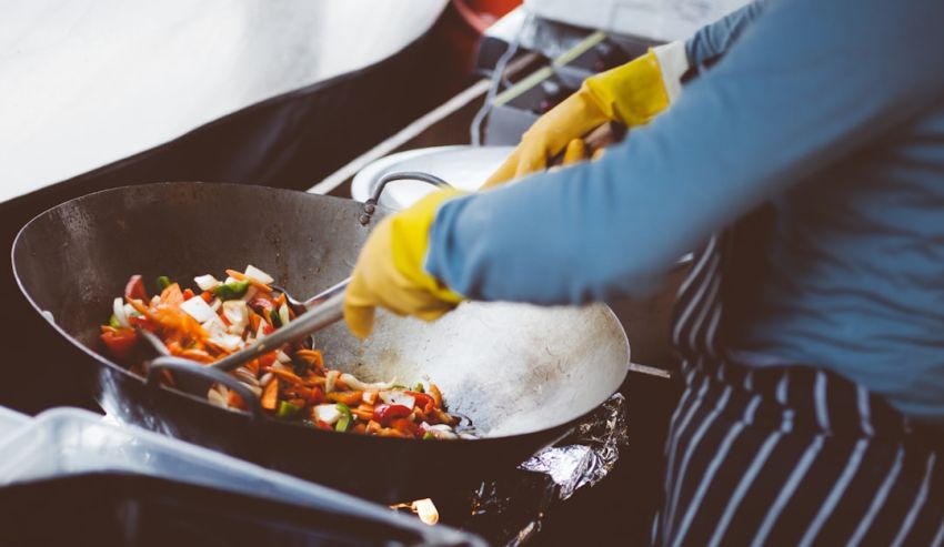 International Cuisines - person mixing vegetable in wok