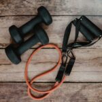 Fitness Equipment - orange and black usb cable on brown wooden surface