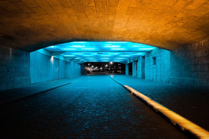 Lighting Solutions - brown and black tunnel with lights turned on during night time